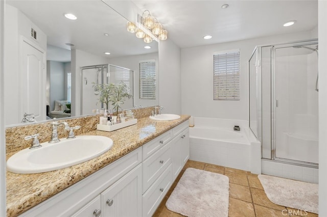 bathroom featuring tile patterned floors, vanity, independent shower and bath, and a notable chandelier