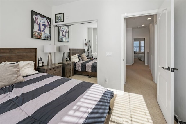 bedroom featuring light carpet and a closet