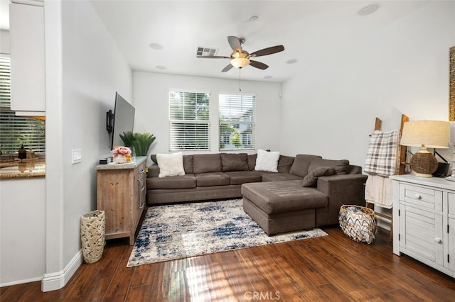 living room with ceiling fan and dark wood-type flooring