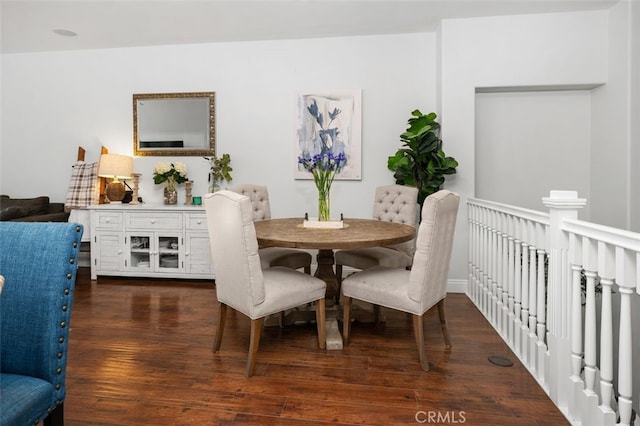 dining space with dark hardwood / wood-style flooring