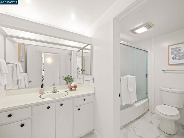 full bathroom with vanity, toilet, and bath / shower combo with glass door