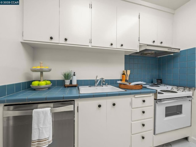 kitchen featuring white electric stove, dishwasher, and white cabinets