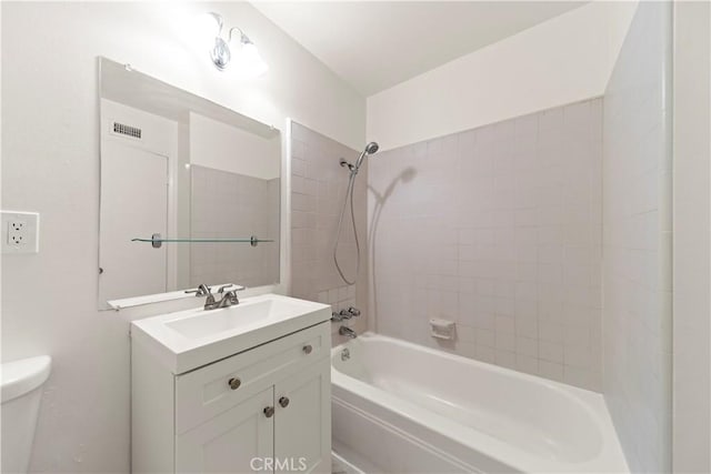 full bathroom with vanity, toilet, and tiled shower / bath