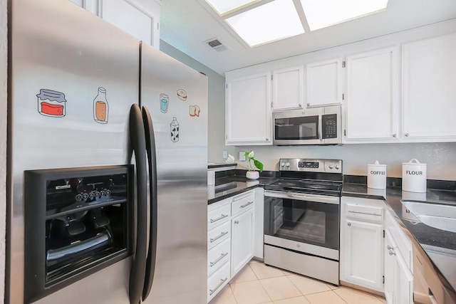 kitchen featuring white cabinetry, appliances with stainless steel finishes, sink, and light tile patterned floors