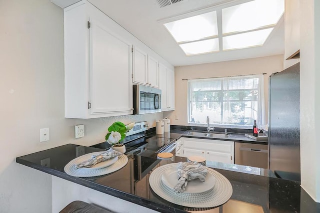 kitchen featuring sink, stainless steel appliances, and white cabinets