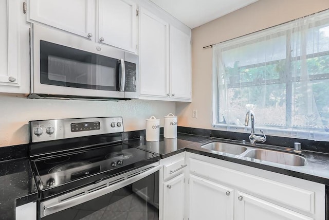 kitchen with white cabinetry, sink, tile patterned floors, and appliances with stainless steel finishes