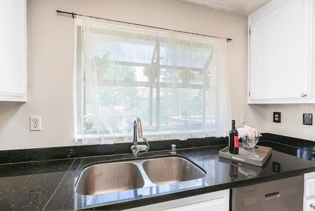 kitchen featuring dishwasher, sink, a wealth of natural light, and white cabinets