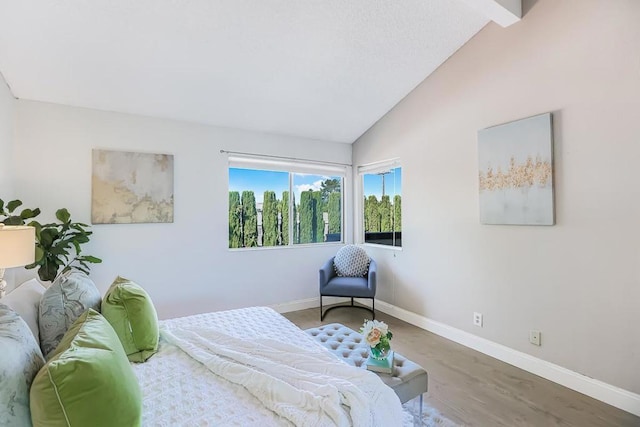 bedroom featuring vaulted ceiling and hardwood / wood-style floors