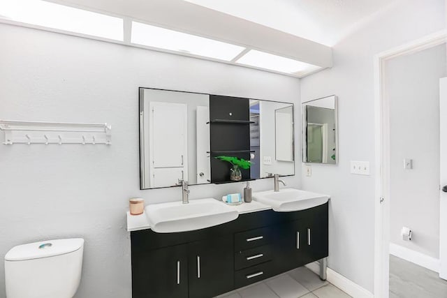 bathroom with vanity, toilet, and tile patterned flooring