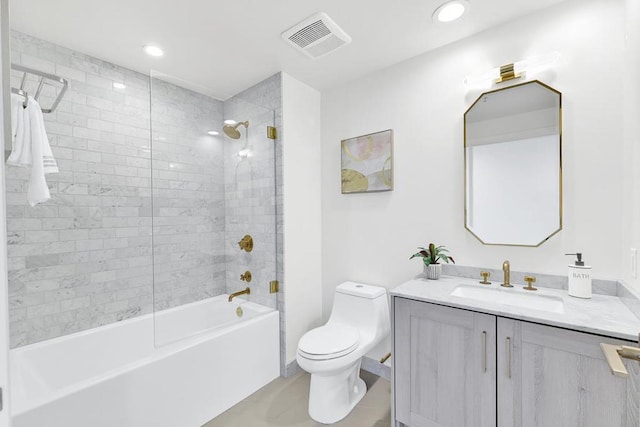 full bathroom featuring tile patterned floors, toilet, vanity, and tiled shower / bath