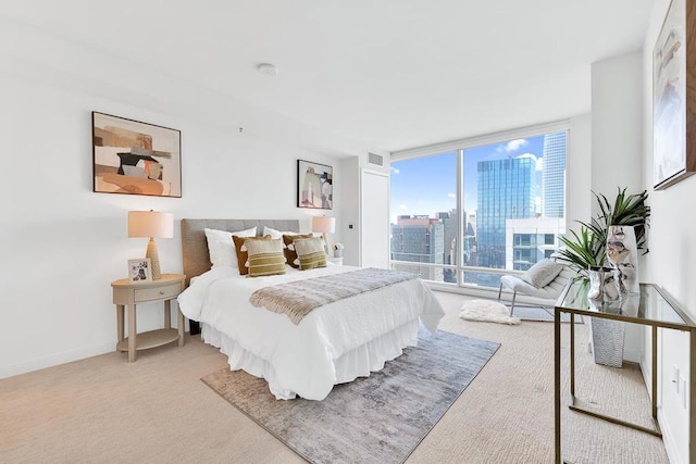 carpeted bedroom featuring floor to ceiling windows