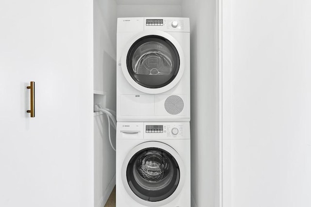 laundry area with stacked washer and clothes dryer