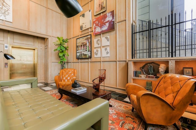 sitting room featuring wood walls