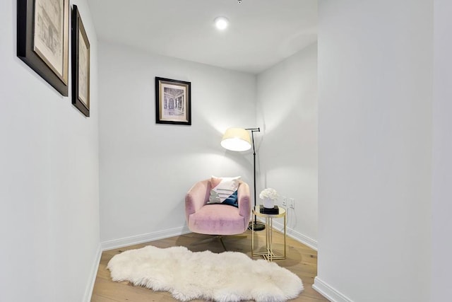 living area with hardwood / wood-style floors