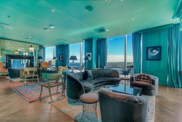 living room featuring floor to ceiling windows and light hardwood / wood-style flooring