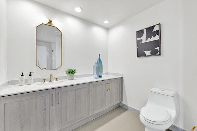 bathroom with tile patterned flooring, vanity, and toilet