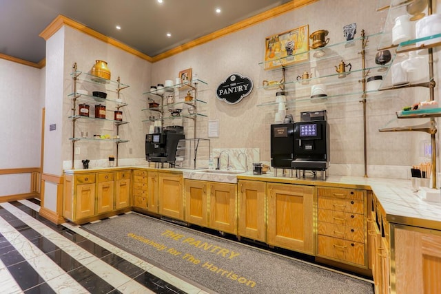 kitchen featuring tile counters, ornamental molding, and sink