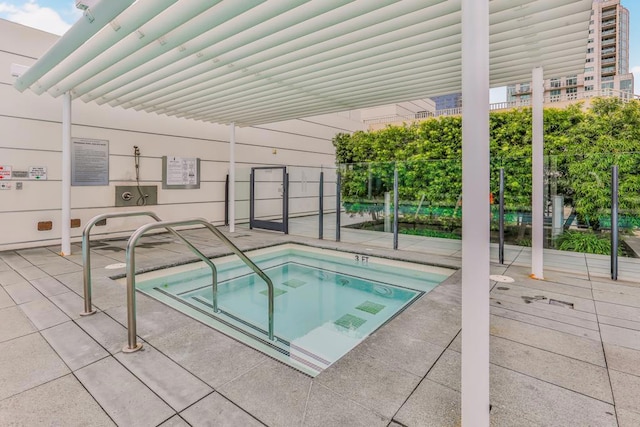 view of swimming pool featuring a community hot tub