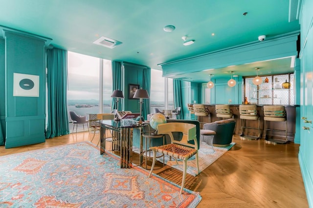 living room with floor to ceiling windows, plenty of natural light, and parquet floors