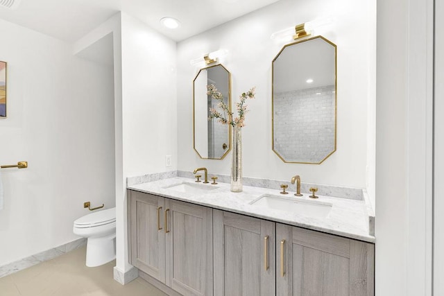 bathroom featuring tile patterned floors, vanity, and toilet