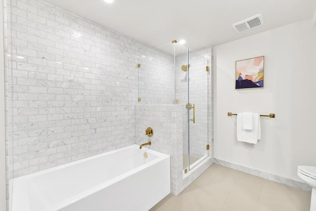 bathroom featuring toilet, tile patterned flooring, and separate shower and tub