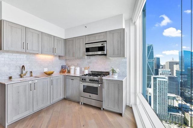 kitchen with stainless steel appliances, plenty of natural light, and sink