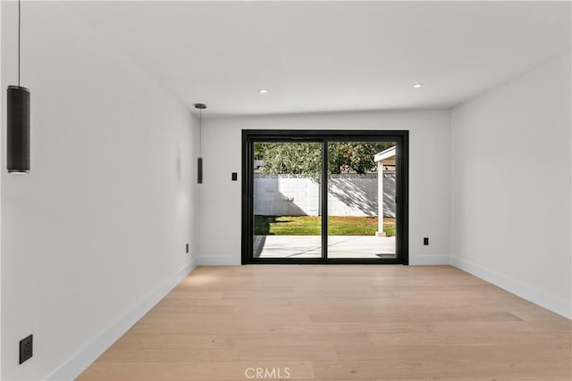 spare room featuring light hardwood / wood-style flooring