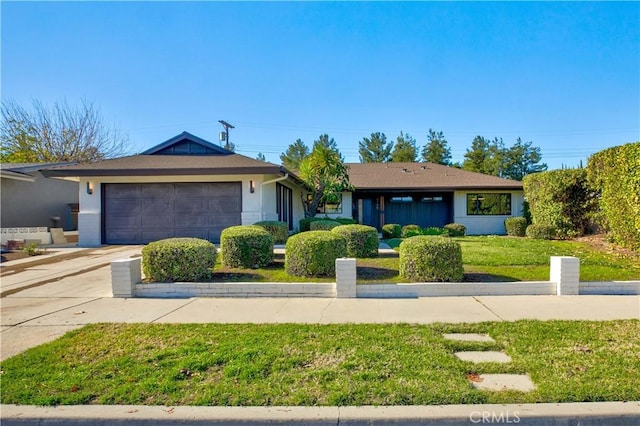 ranch-style home with a garage and a front yard