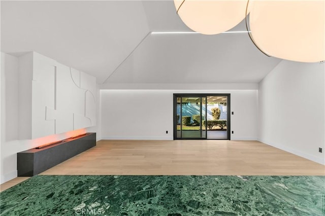 living room with wood-type flooring and vaulted ceiling