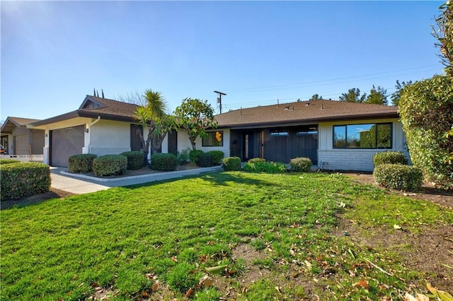 single story home featuring a garage and a front yard