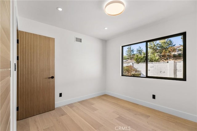 unfurnished room featuring light hardwood / wood-style flooring