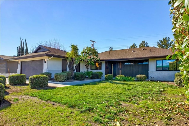 ranch-style home featuring a garage and a front lawn