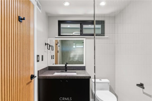 bathroom featuring vanity and toilet