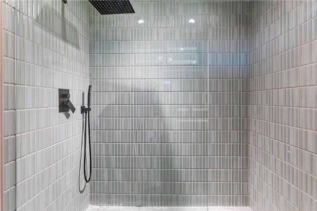 bathroom with a tile shower