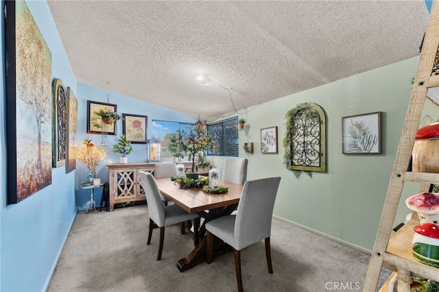 dining room with carpet, lofted ceiling, and a textured ceiling