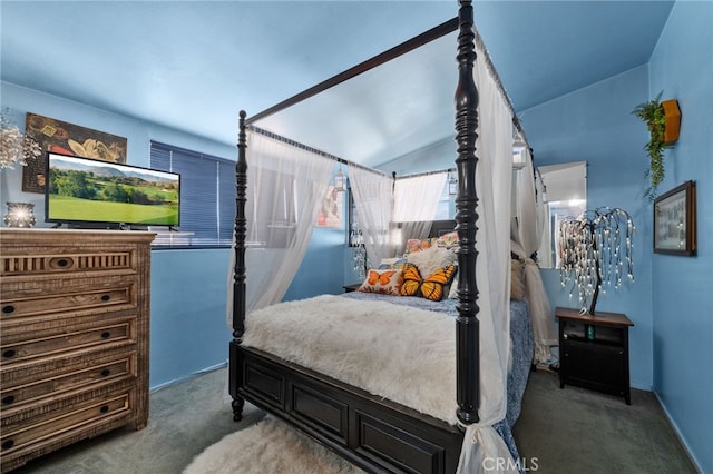 carpeted bedroom featuring lofted ceiling