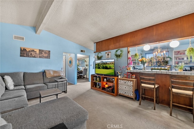 carpeted living room featuring a chandelier, a textured ceiling, lofted ceiling with beams, and wooden walls