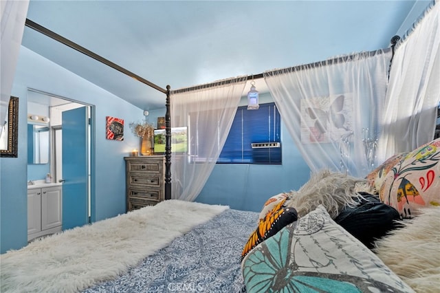 bedroom featuring connected bathroom and lofted ceiling