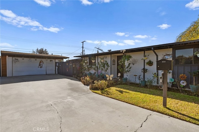 single story home featuring a front lawn and a garage