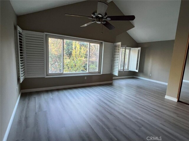 unfurnished living room with ceiling fan, hardwood / wood-style floors, and lofted ceiling