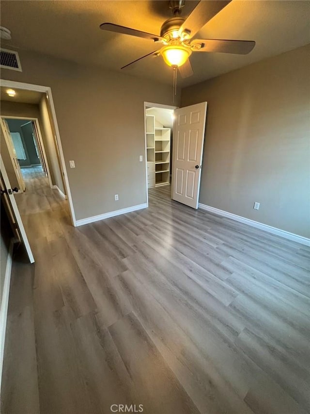 unfurnished room with ceiling fan and hardwood / wood-style floors