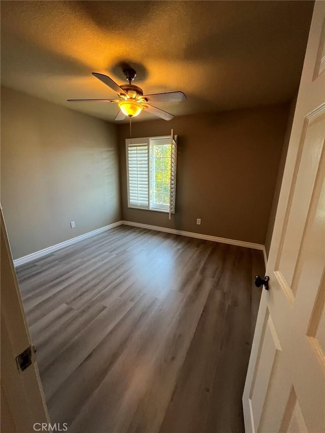 empty room featuring a textured ceiling, ceiling fan, and hardwood / wood-style floors