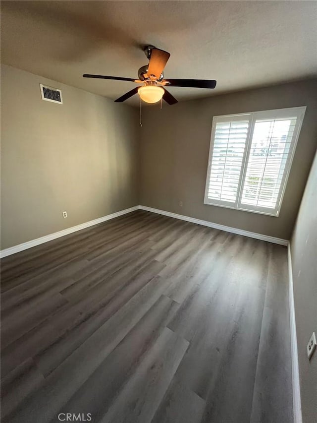 unfurnished room featuring ceiling fan and dark hardwood / wood-style flooring