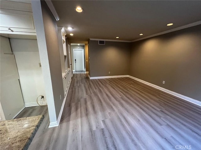 basement featuring wood-type flooring and ornamental molding