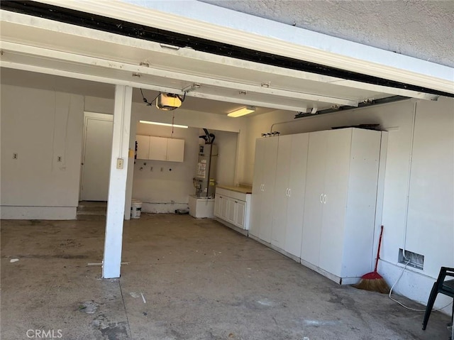 garage with water heater and a garage door opener