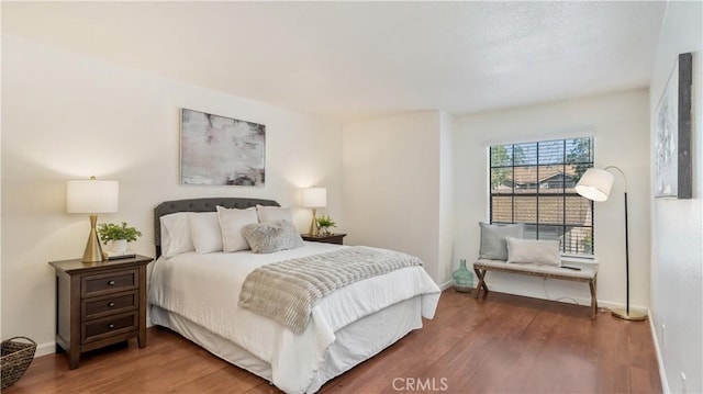 bedroom with dark hardwood / wood-style flooring