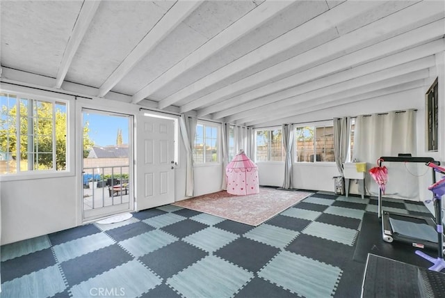 sunroom / solarium featuring beam ceiling