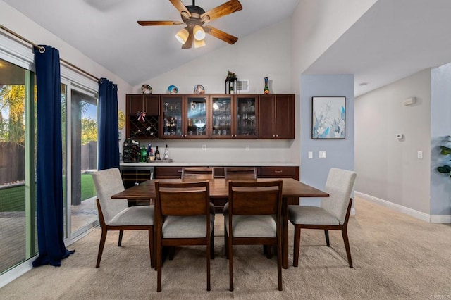 bar featuring light carpet, dark brown cabinetry, ceiling fan, and lofted ceiling