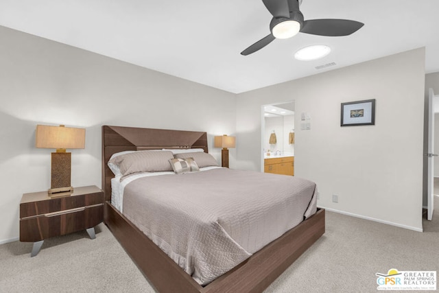 bedroom with ensuite bath, ceiling fan, and light carpet