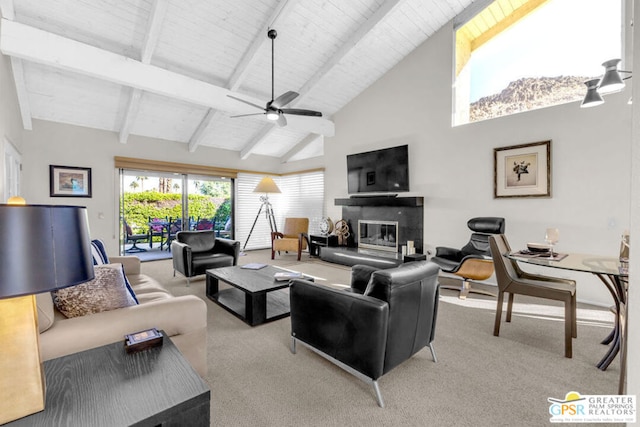 carpeted living room with beamed ceiling, ceiling fan, and high vaulted ceiling